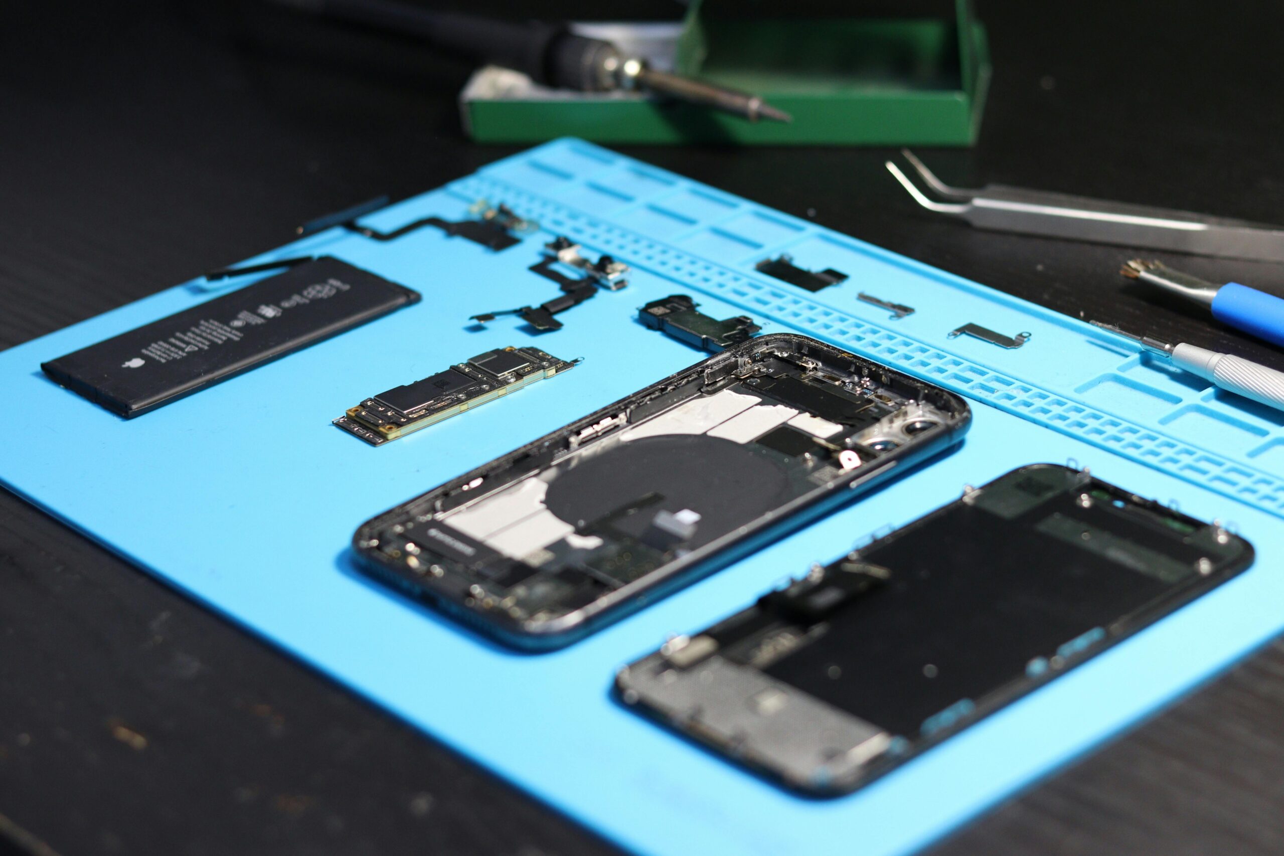Smartphone repair tools and electronic components on a workbench